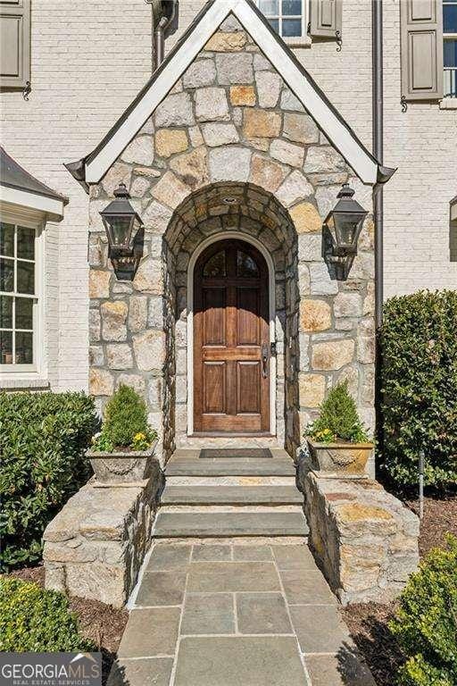 doorway to property with stone siding