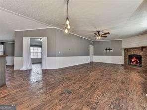 unfurnished living room featuring a fireplace and ceiling fan