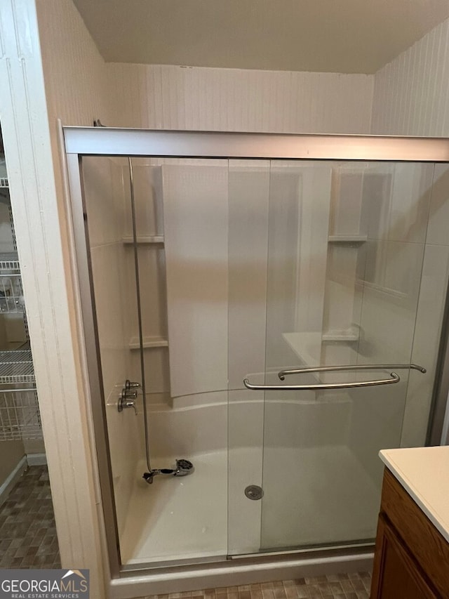 full bath featuring vanity and an enclosed shower