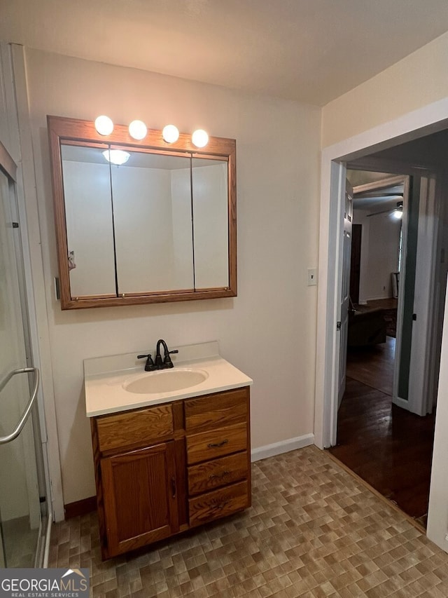 bathroom featuring baseboards and vanity