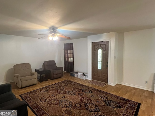 entryway with ceiling fan, baseboards, and wood finished floors