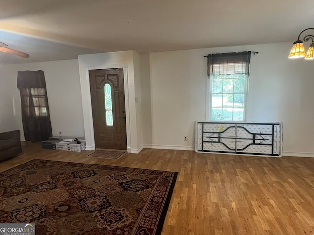 foyer featuring wood finished floors and baseboards