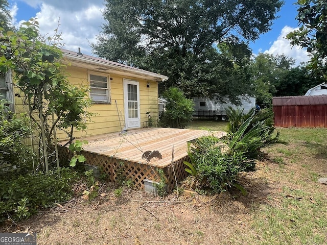 exterior space featuring fence and a wooden deck