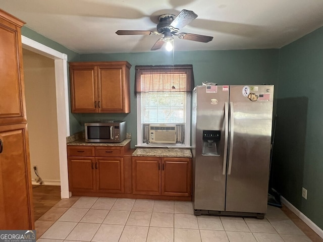 kitchen with ceiling fan, brown cabinets, cooling unit, appliances with stainless steel finishes, and light tile patterned flooring