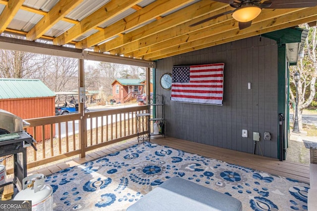 deck with grilling area and a ceiling fan