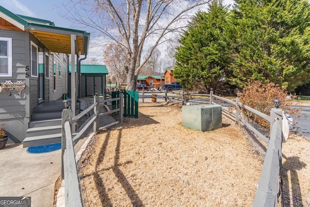 view of yard with an outbuilding, a storage shed, and fence