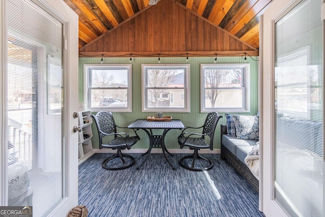 sunroom / solarium featuring vaulted ceiling and wooden ceiling