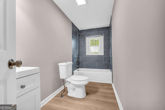 full bathroom featuring baseboards, toilet, shower / tub combination, wood finished floors, and vanity