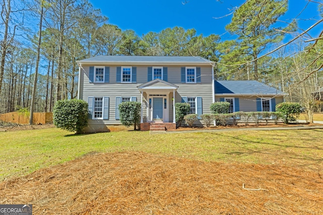 colonial home featuring a front yard