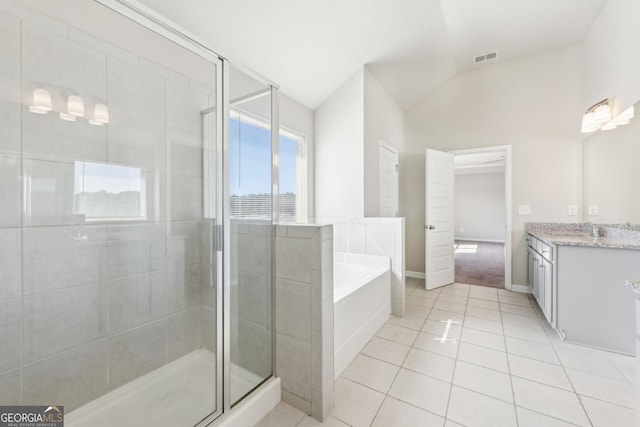 7783 Hansel Ln, Lithonia, GA 30058 - bathroom with tile patterned flooring, vaulted ceiling, vanity, a shower stall, and a bath