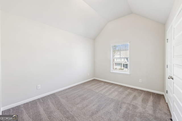 7783 Hansel Ln, Lithonia, GA 30058 - unfurnished bedroom featuring carpet flooring, vaulted ceiling, and baseboards