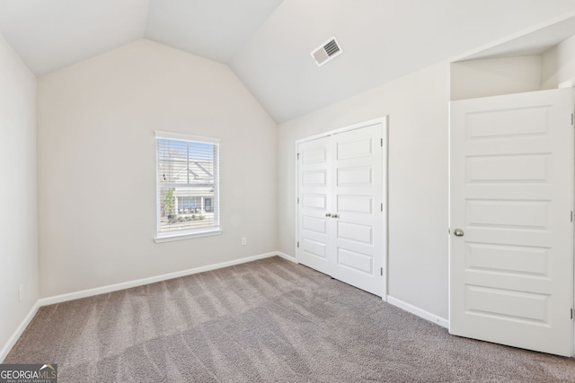 7783 Hansel Ln, Lithonia, GA 30058 - unfurnished bedroom with carpet, lofted ceiling, and baseboards