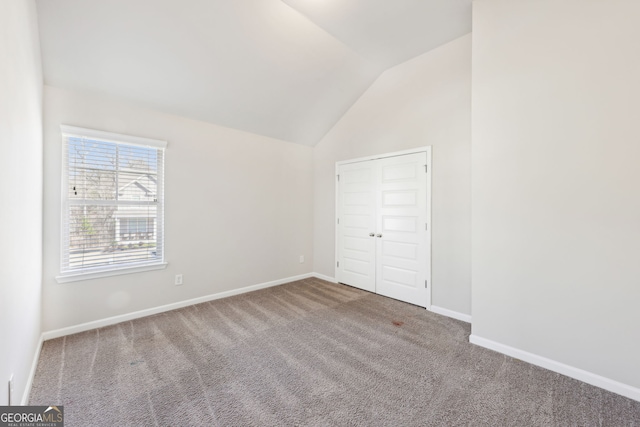 7783 Hansel Ln, Lithonia, GA 30058 - unfurnished bedroom featuring carpet flooring, vaulted ceiling, and baseboards