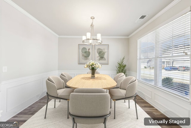 7783 Hansel Ln, Lithonia, GA 30058 - dining room featuring a chandelier, wood finished floors, ornamental molding, and wainscoting