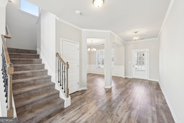 7783 Hansel Ln, Lithonia, GA 30058 - foyer with a chandelier, wood finished floors, stairway, crown molding, and baseboards