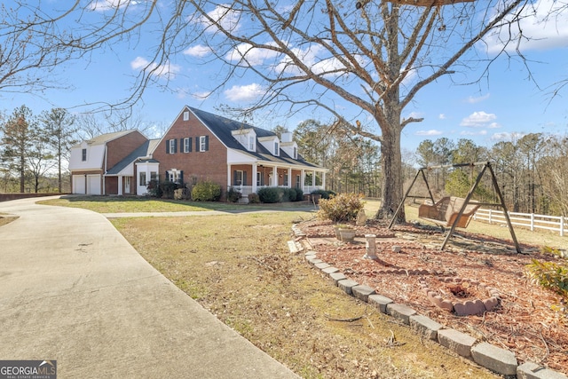 view of home's exterior featuring fence, concrete driveway, a garage, a lawn, and brick siding