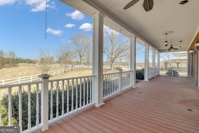 wooden deck featuring a ceiling fan and fence