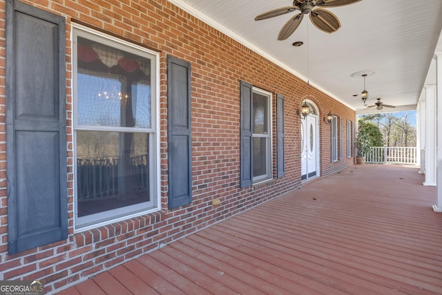 wooden terrace with a porch and a ceiling fan