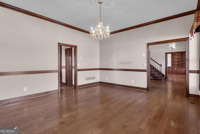 spare room with visible vents, baseboards, stairs, ornamental molding, and wood finished floors