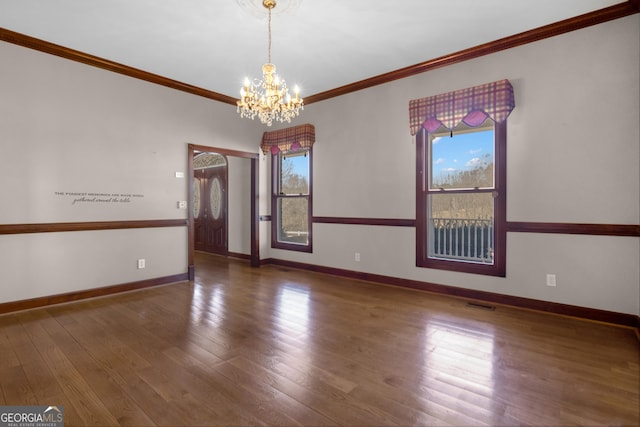 unfurnished room with a healthy amount of sunlight, crown molding, baseboards, and wood finished floors