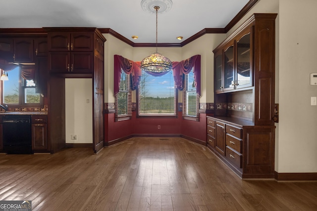 unfurnished dining area featuring crown molding, dark wood-style floors, and baseboards