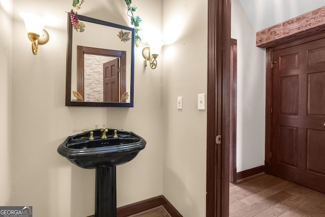 bathroom featuring baseboards and wood finished floors