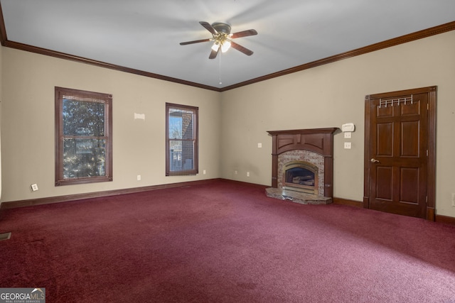 unfurnished living room featuring a ceiling fan, dark carpet, a fireplace, crown molding, and baseboards