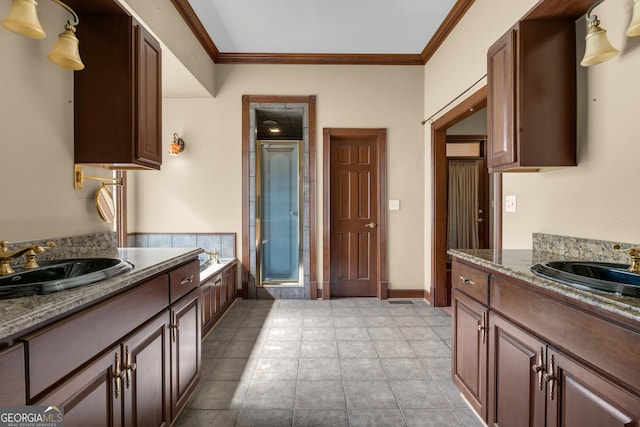 full bath featuring a sink, a stall shower, crown molding, and tile patterned flooring