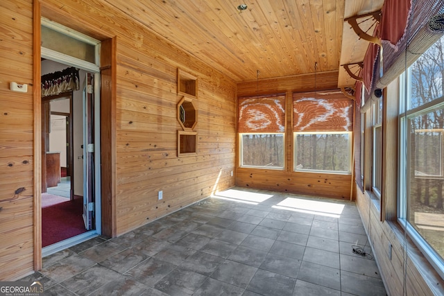 unfurnished sunroom with wooden ceiling