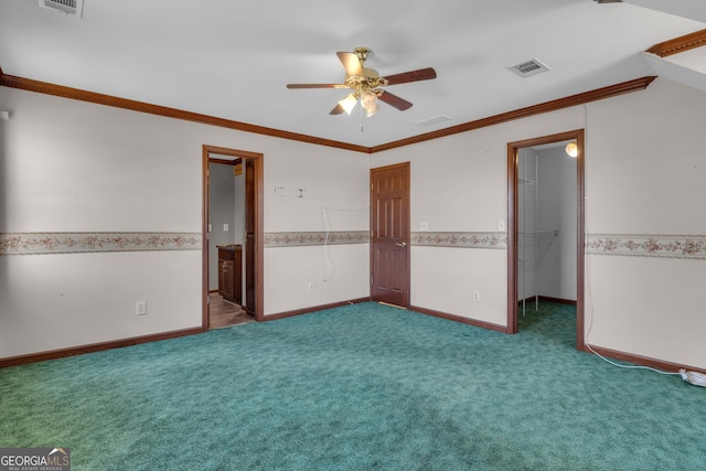 carpeted spare room featuring visible vents, wainscoting, ceiling fan, and ornamental molding