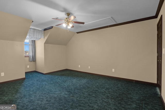 additional living space with a ceiling fan, baseboards, attic access, vaulted ceiling, and dark carpet