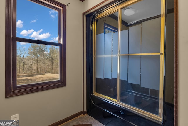 interior space featuring tile patterned flooring and baseboards