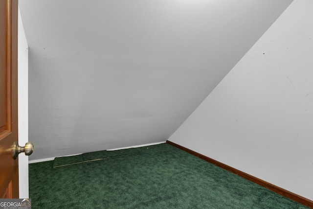 carpeted empty room featuring baseboards