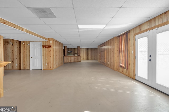 basement with wooden walls and plenty of natural light