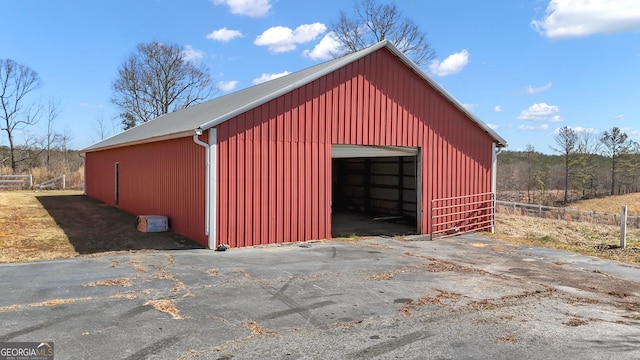 view of pole building featuring fence