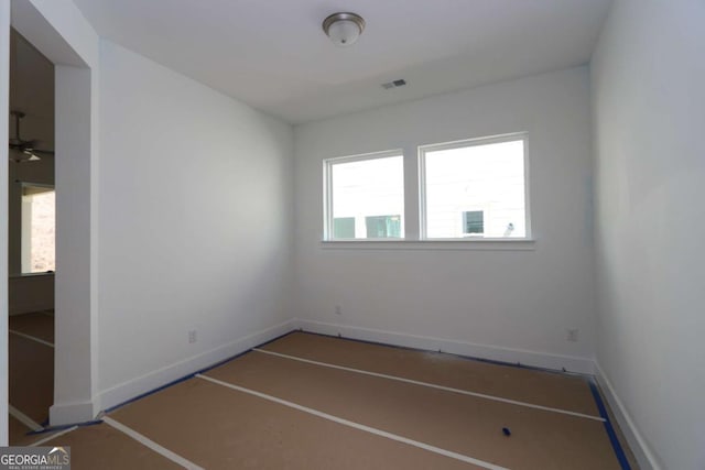 empty room with visible vents and baseboards