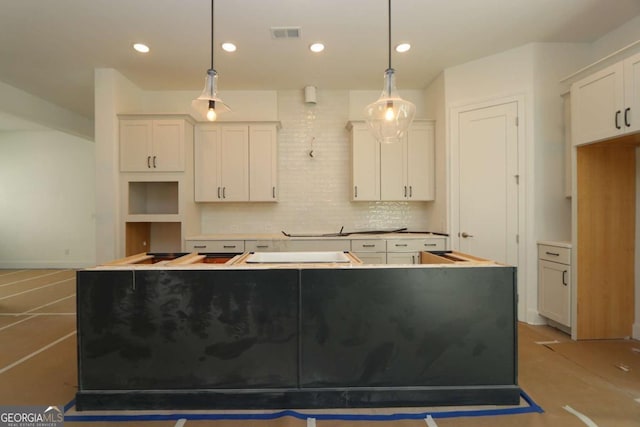 kitchen with decorative light fixtures, tasteful backsplash, a center island, white cabinetry, and recessed lighting