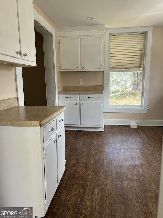 kitchen featuring white cabinetry, baseboards, and dark wood-style flooring