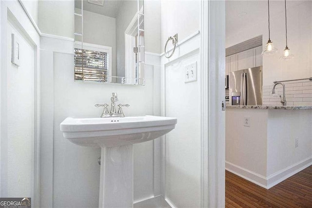 bathroom with baseboards and wood finished floors