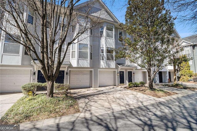 view of front of home featuring concrete driveway and an attached garage