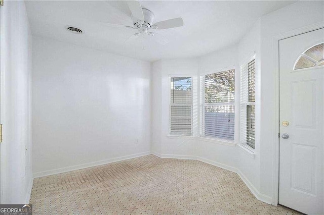 interior space featuring a ceiling fan, baseboards, and visible vents