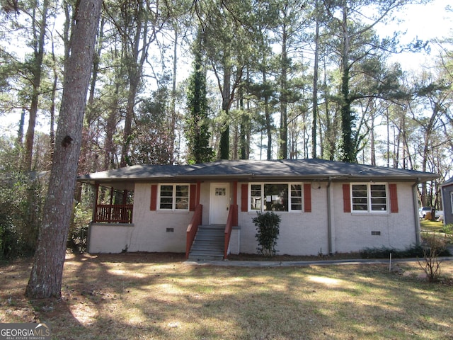 ranch-style house featuring a front yard, brick siding, and crawl space