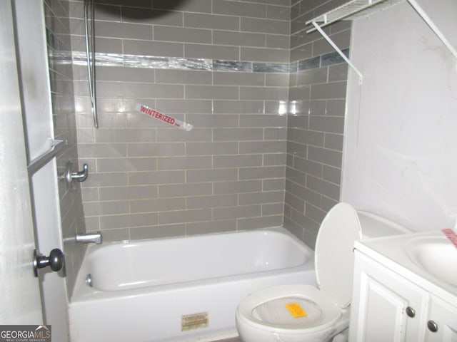 bathroom featuring vanity, toilet, and washtub / shower combination