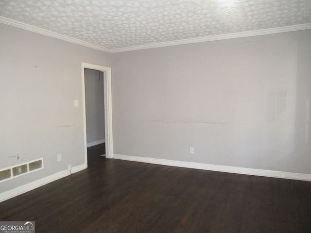 empty room with wood finished floors, visible vents, baseboards, a textured ceiling, and crown molding