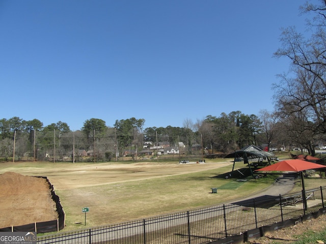 view of home's community featuring a yard and fence