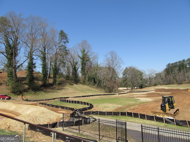 view of home's community featuring a yard and fence