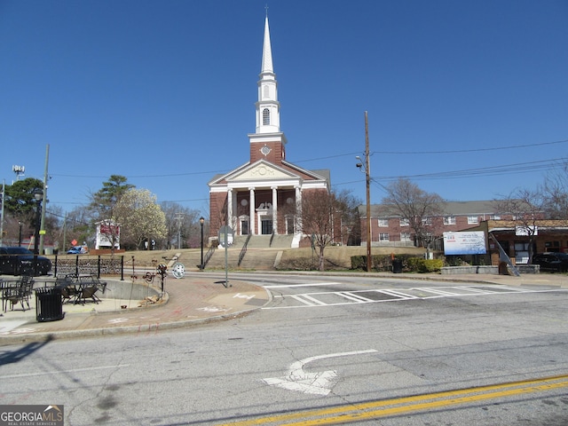 exterior space featuring street lights, curbs, and sidewalks