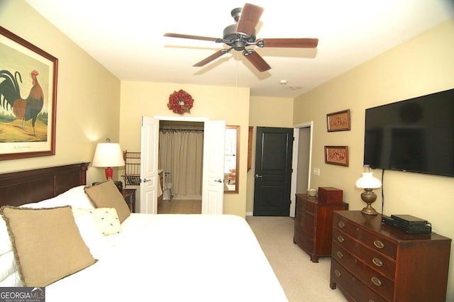 bedroom featuring light colored carpet and a ceiling fan