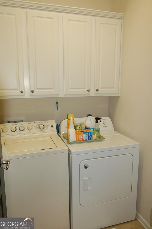 washroom featuring washer and clothes dryer and cabinet space