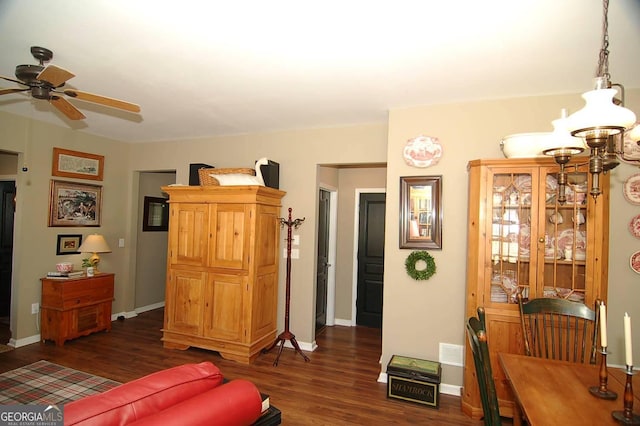 living area featuring visible vents, baseboards, and dark wood-style flooring